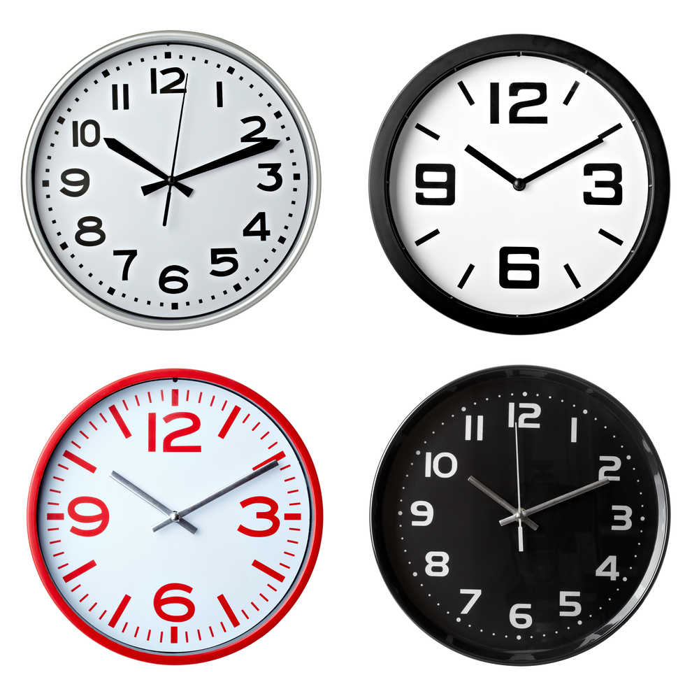 collection of various office clocks on white background. each one is shot separately